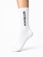 White knee-high sock on a leg with bold black vertical text along the side reading 'NOT FOR SAKEN'.