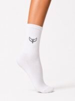 White crew sock on a leg featuring a small black minimalist wing logo on the side.