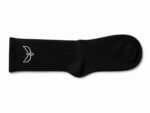 Black sock laid flat with a ribbed leg and smooth toe, featuring a white minimalist bird logo near the cuff on the outside.