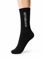 Black knee-high sock with white vertical text reading 'NOT FOR SNEAKERS' against a white background