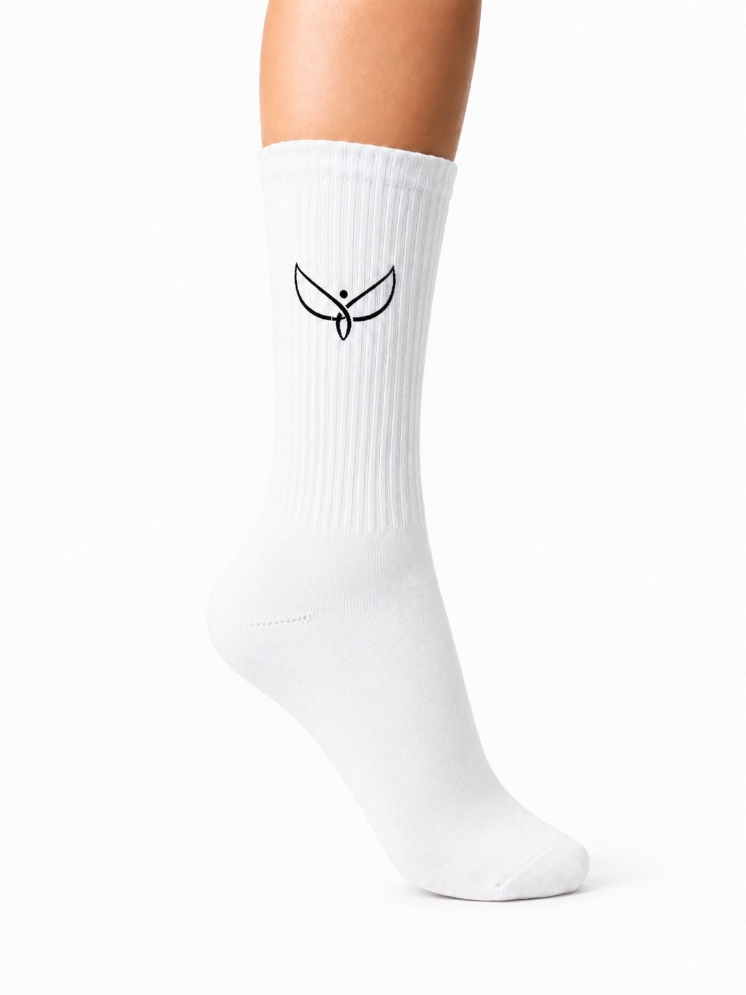85feca75-2ee5-4bad-91a9-5d20555f5234 - NOTFORSAKEN COLLECTION White knee-high sock on a leg with a small black bird logo on the shin area, ribbed texture visible against a white background